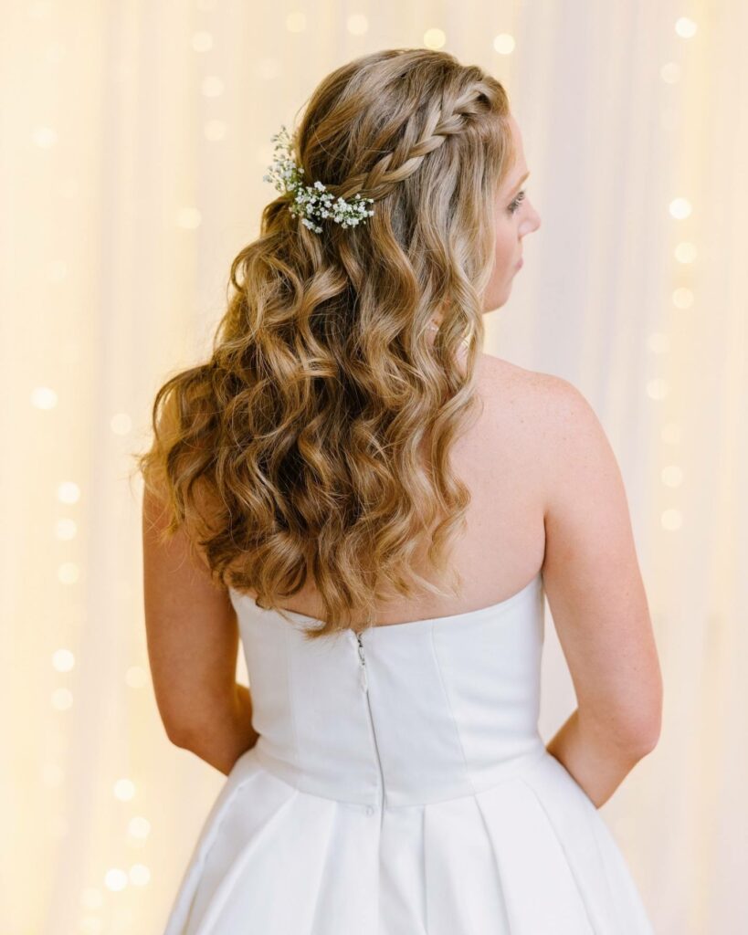 half up long waves and braid at crown wedding hairstyle with baby breath