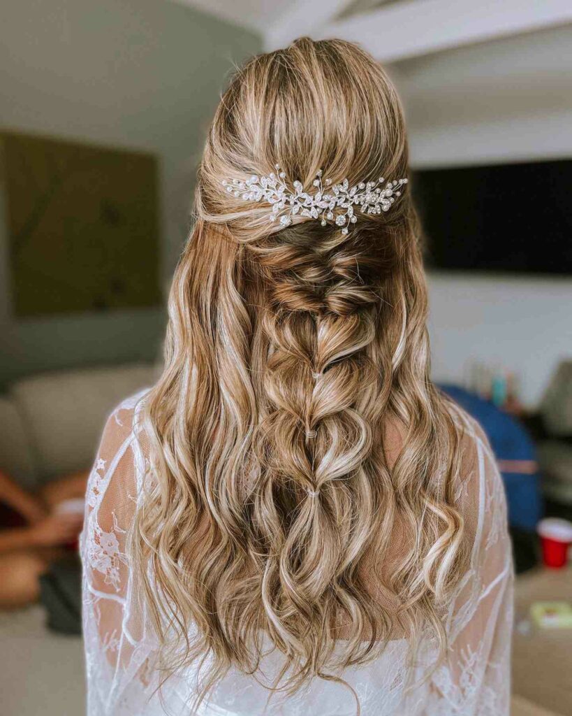 half updo wedding hairstyle with fishtail braided and hair piece