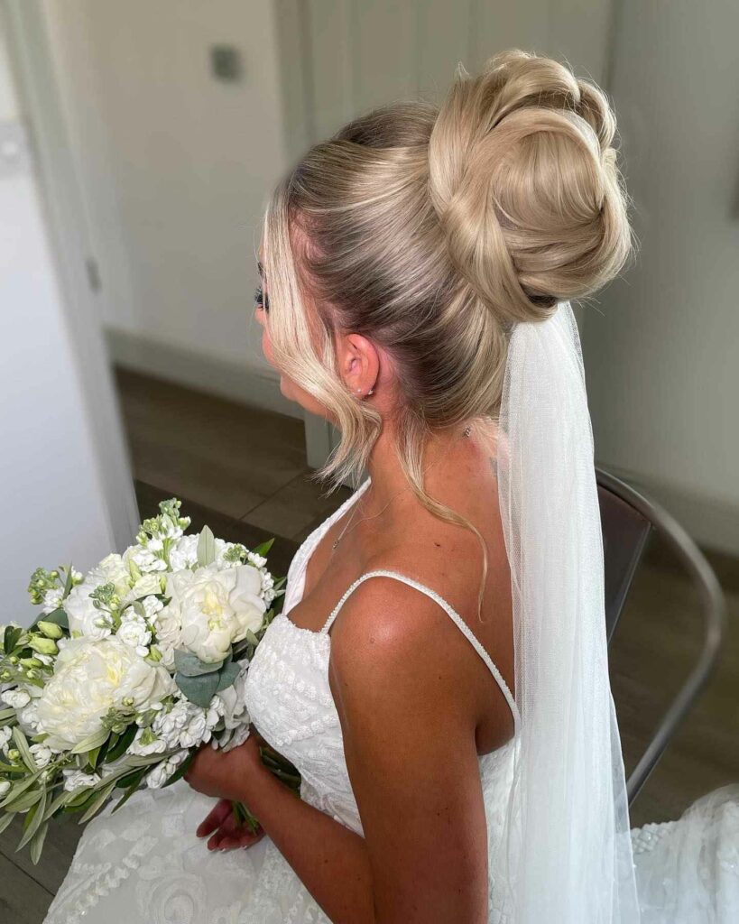 high bun with long hair and veil wedding hairstyle