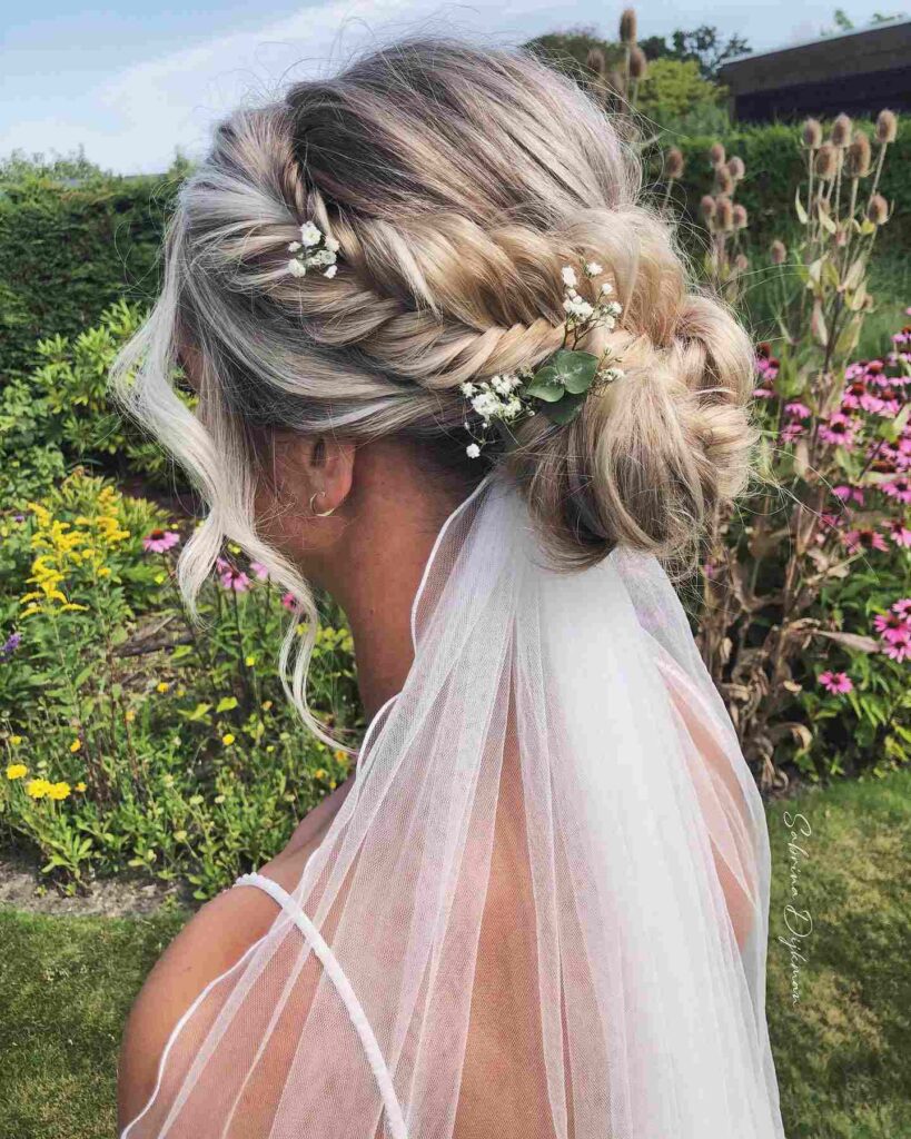 low bun wedding hairstyle with clip in braid and veil