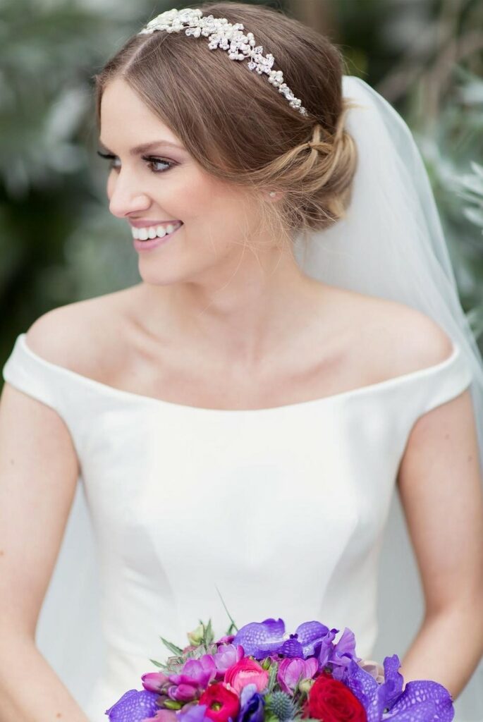 low bun wedding hairstyle with tiara and veils