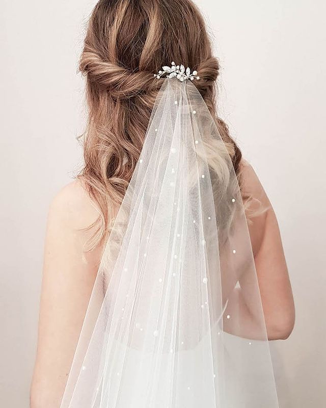 romantic half up wedding hairstyle with pearl hair pin and veil for chic bridal look