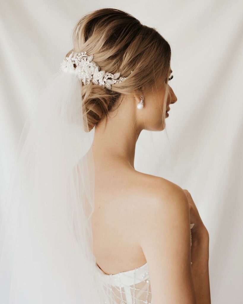 romantic low bun with the veil and hair piece long wedding hairstyle