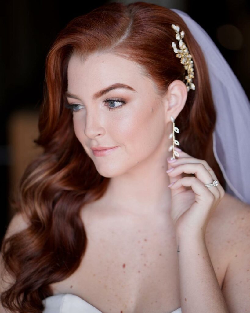 side swept wedding hairstyle with pearl accent jewelry hair piece and veil