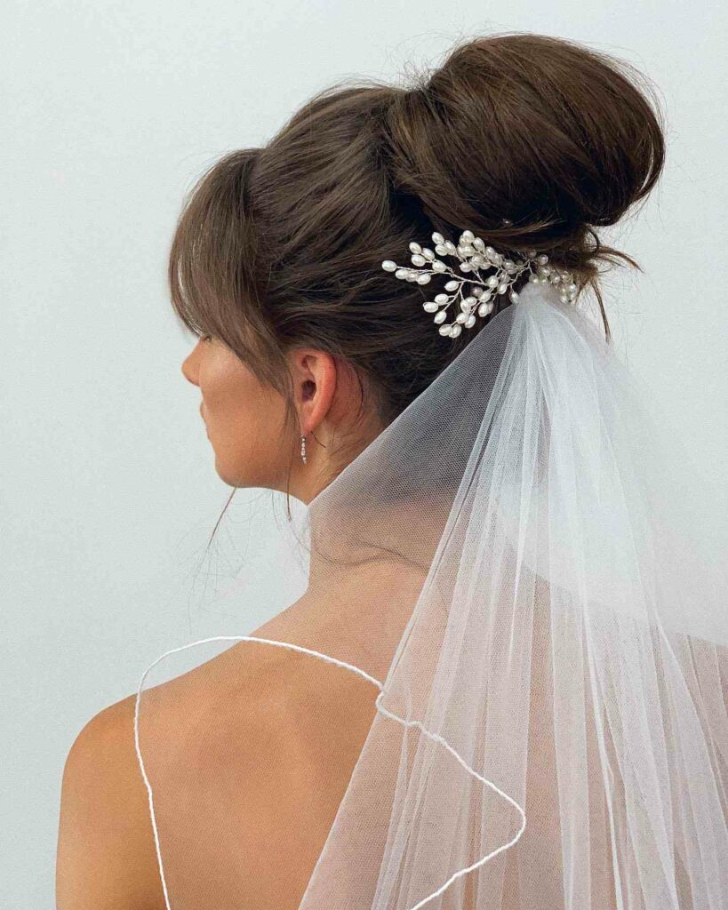 simple high bun with veil wedding hairstyle