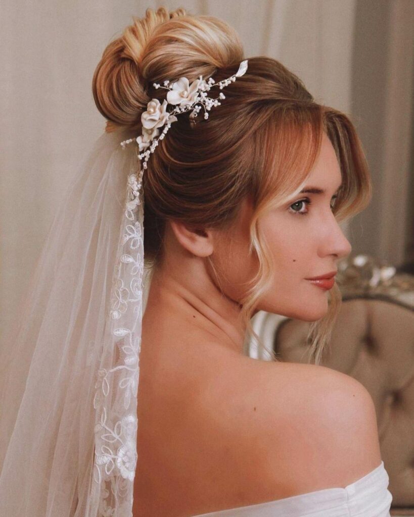 top knot wedding hairstyle for long hair with a vine and veil