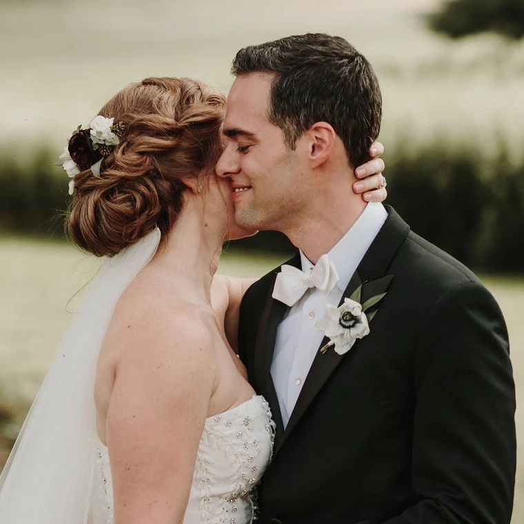 twisted textured chignon wedding hairstyle with flowers and veil