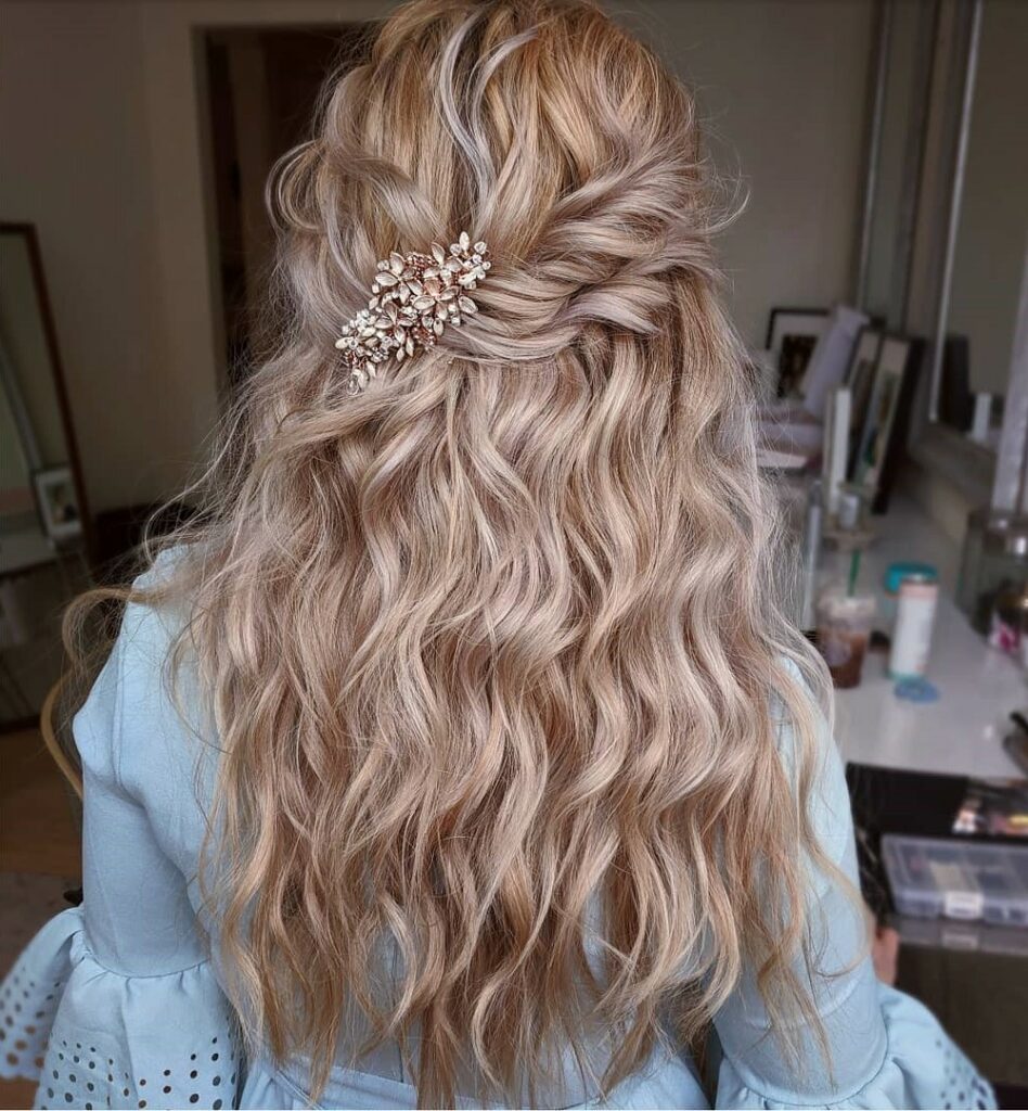 whimsical half up and half down wavy wedding hairstyle with hair piece