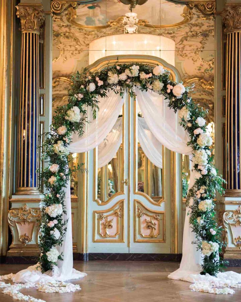 beautiful greenery and gold wedding arch with white roses