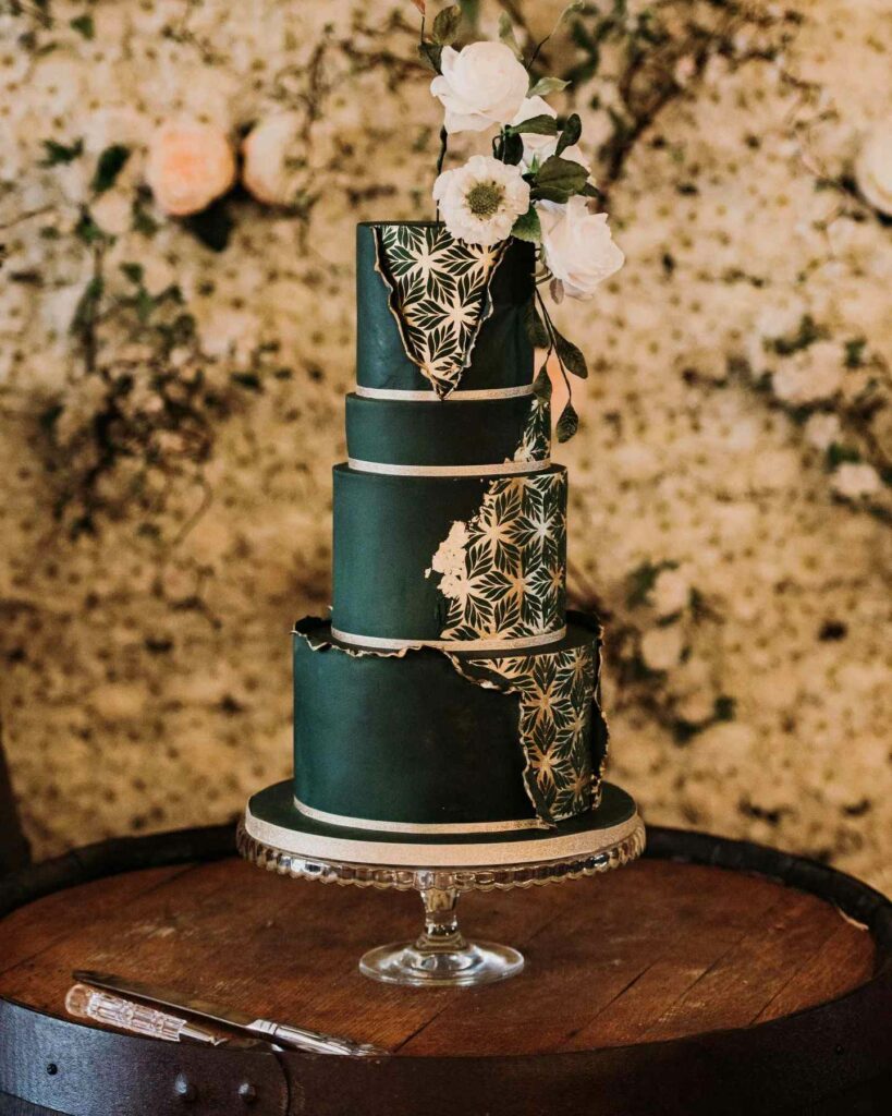 deep and dark emerald and edible gold leaf sugar flowers wedding cake