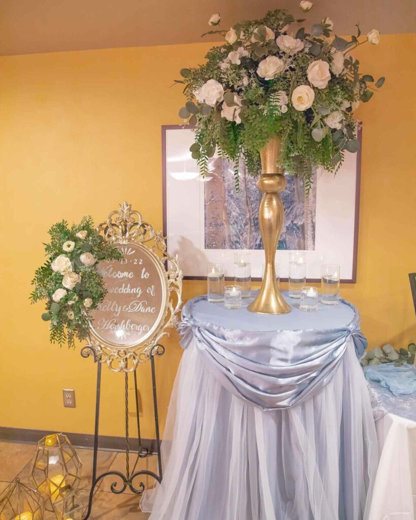 dusty blue welcome table with wedding centerpiece ideas