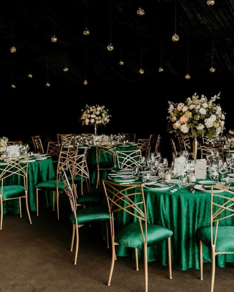 emerald green and gold wedding table setting with tall centerpiece