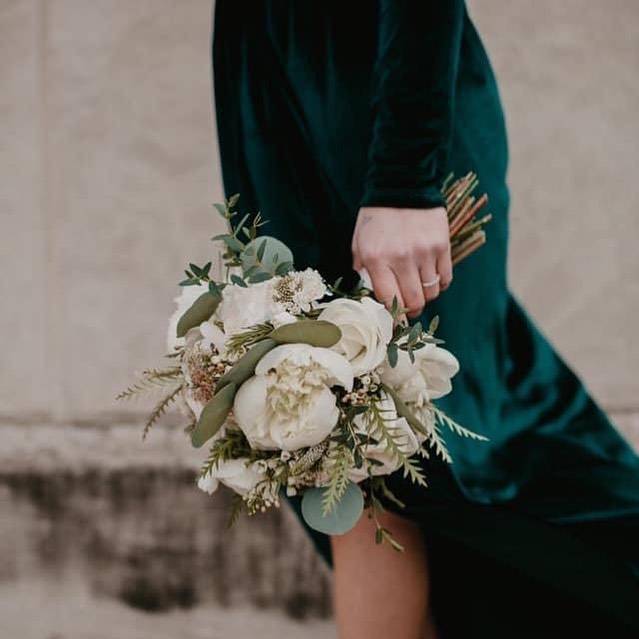 emerald green dress with gold wedding bouquet