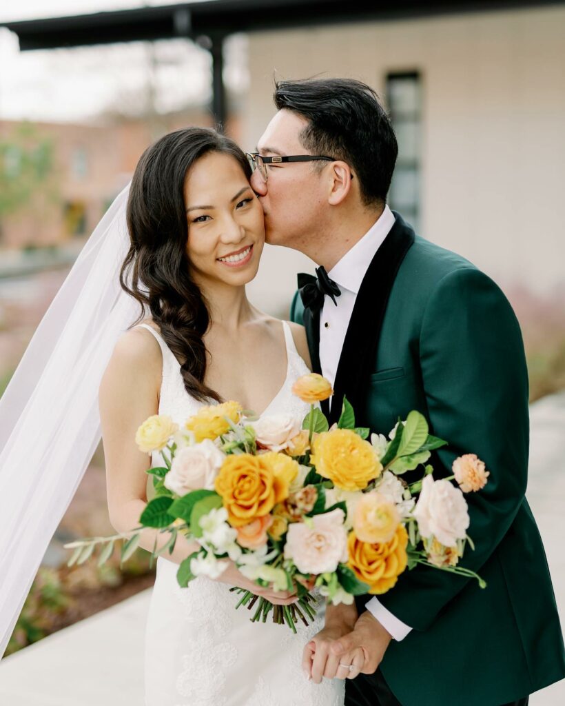 emerald green groom attire with golden wedding bouquet