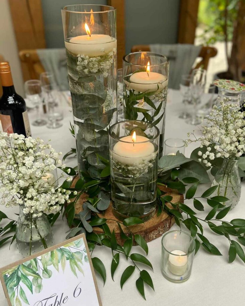 floating candle with wooden stump wedding centerpiece and baby's breath