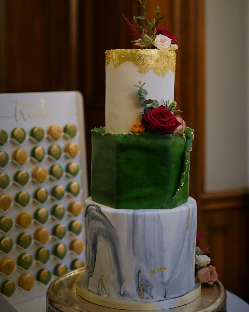 green and gold leaf winter wedding cake with rose