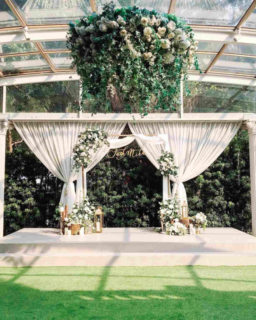 green and gold natural wedding ceremony arch backdrop