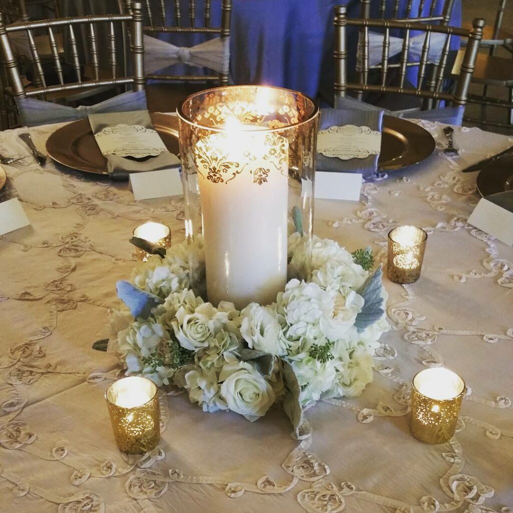 grey and gold wedding candle table color scheme with wreath of flowers