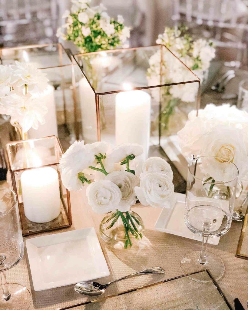 lantern wedding centerpiece with candles and white roses