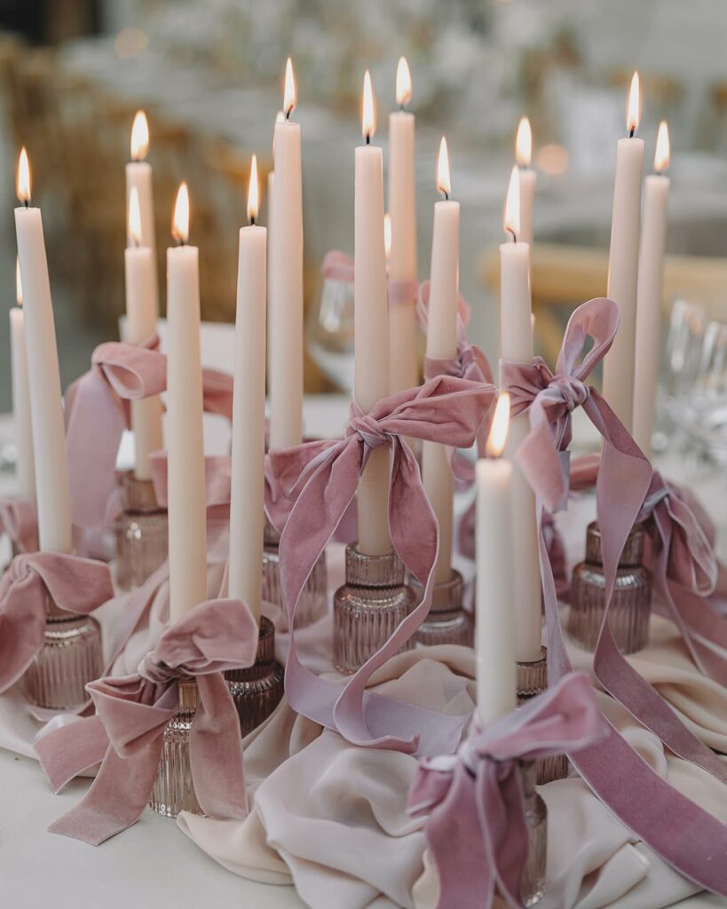 mass of taper candle wedding centerpiece with bows