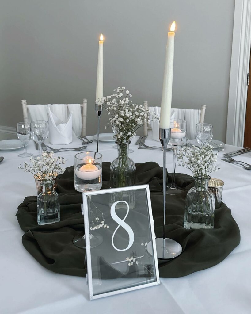 minimalistic black and white wedding centerpiece with taper candles
