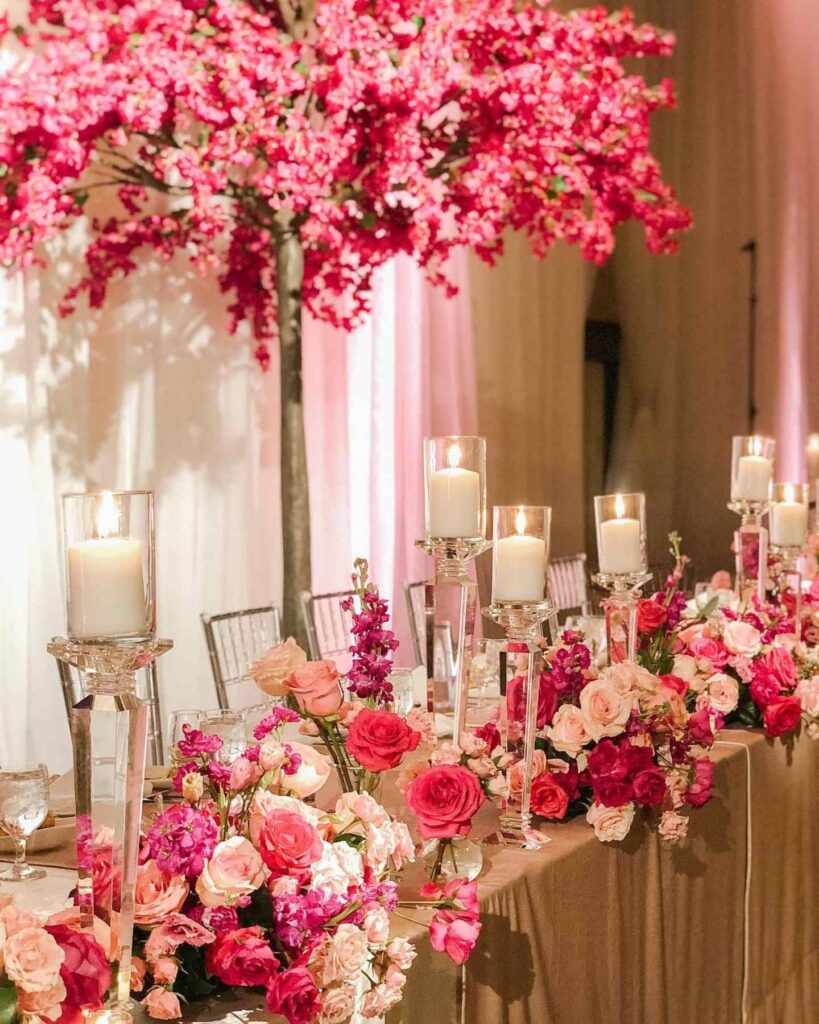 pillar candle wedding centerpiece with pink floral arrangements