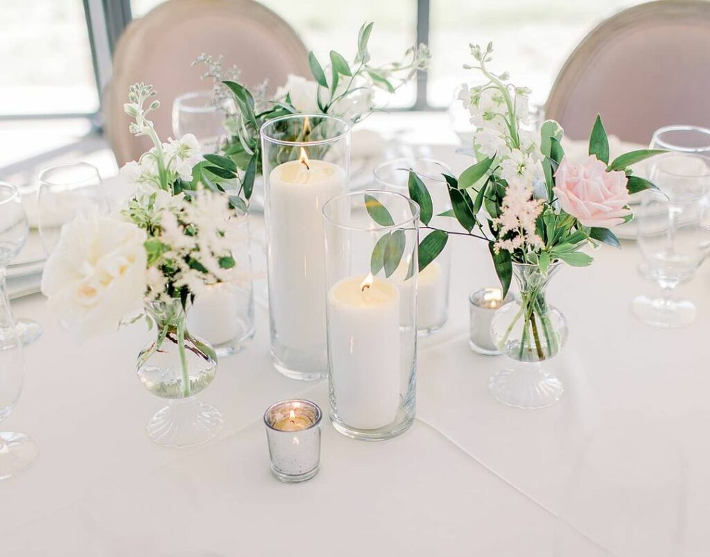 pillar candles wedding centerpiece with sweet little bud vase floral arrangements for a perfect mix of glowing candlelight and soft textured blooms