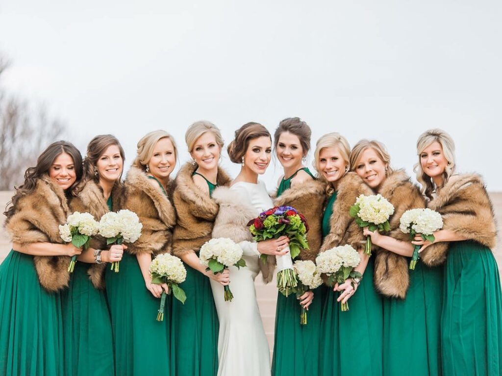 regal fur capes with emerald and gold bridesmaid wedding dress