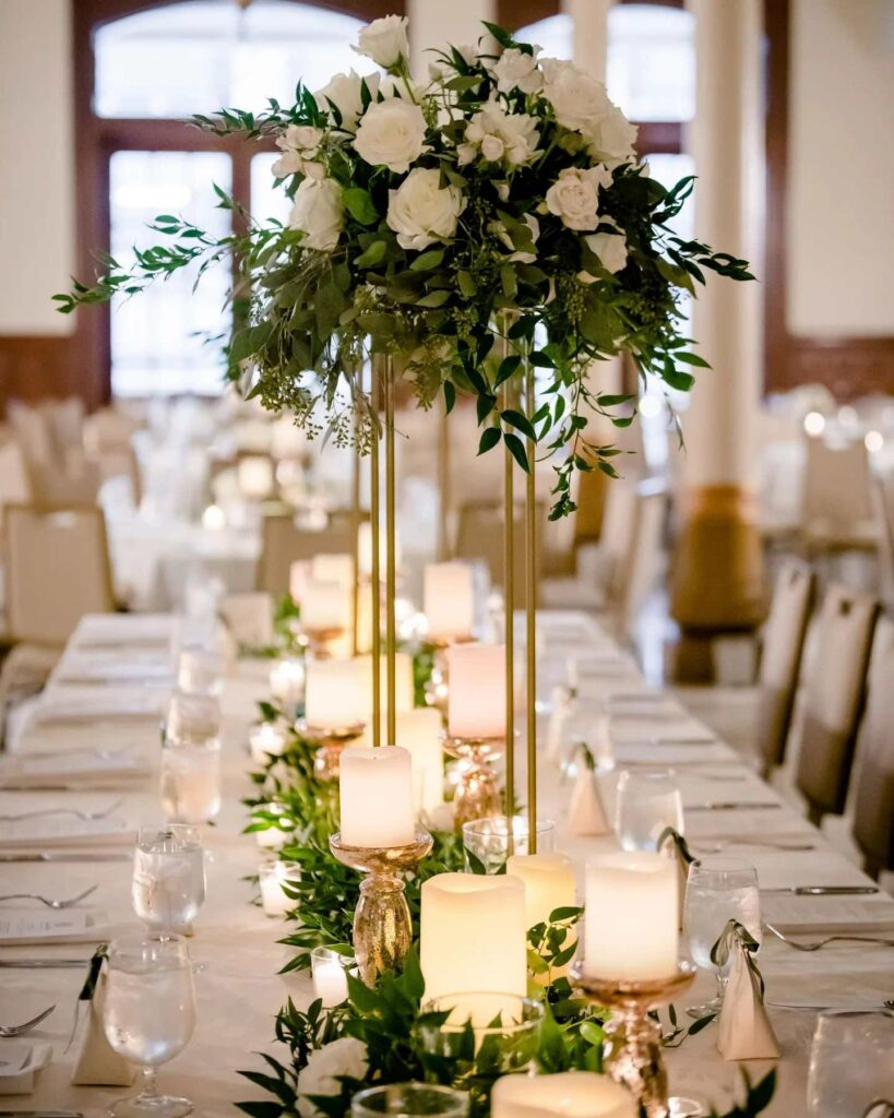 romantic and gorgeous wedding table gold mercury glass pillar candles with a greenery runner