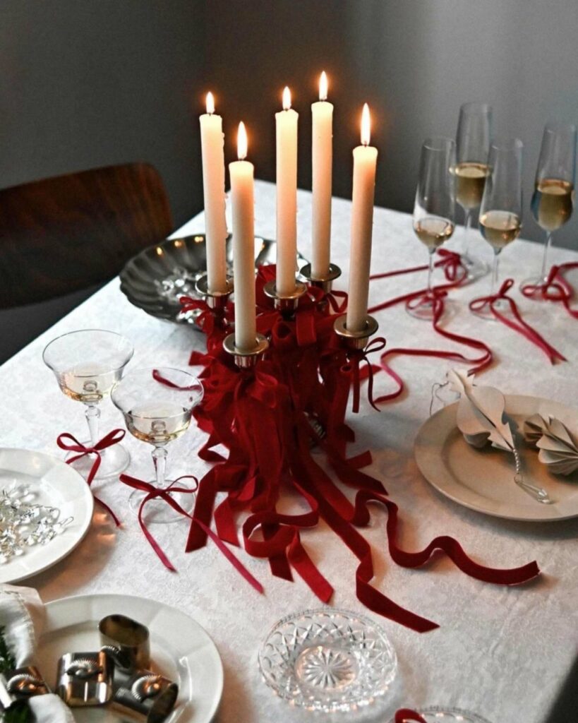 romantic taper candle wedding centerpiece with red bow