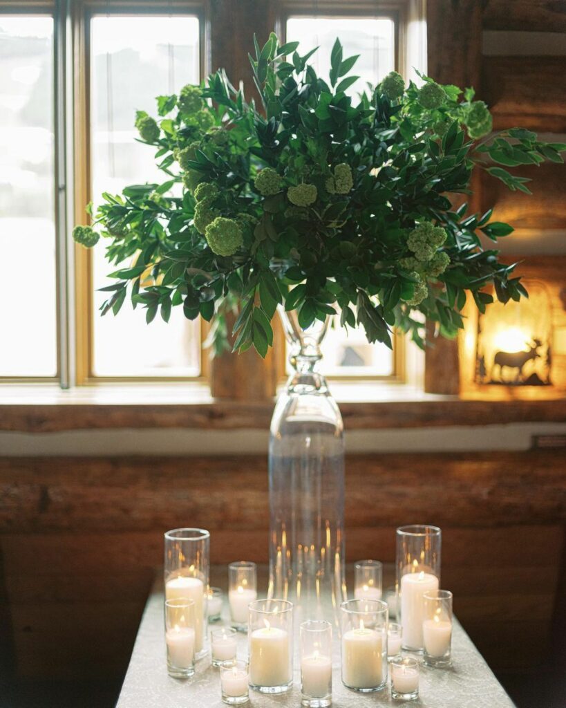 simple and minimal greenery and candles wedding centerpiece on budget
