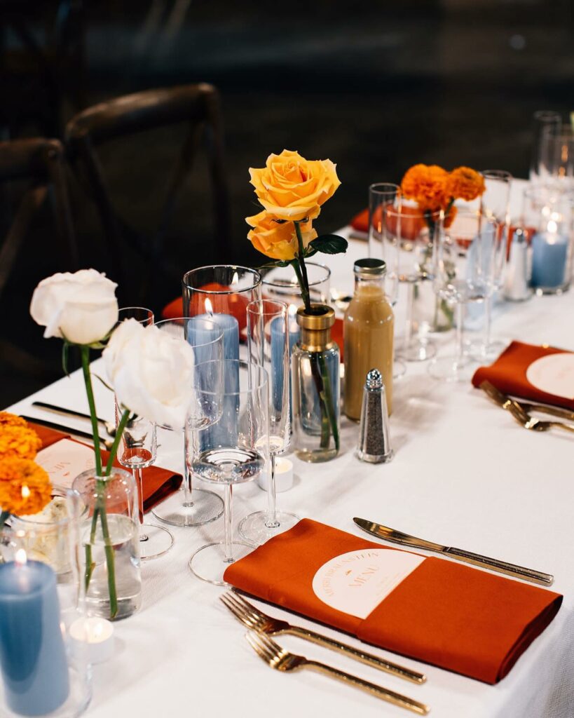 vibrant wedding centerpiece with pillar candles for fall setting