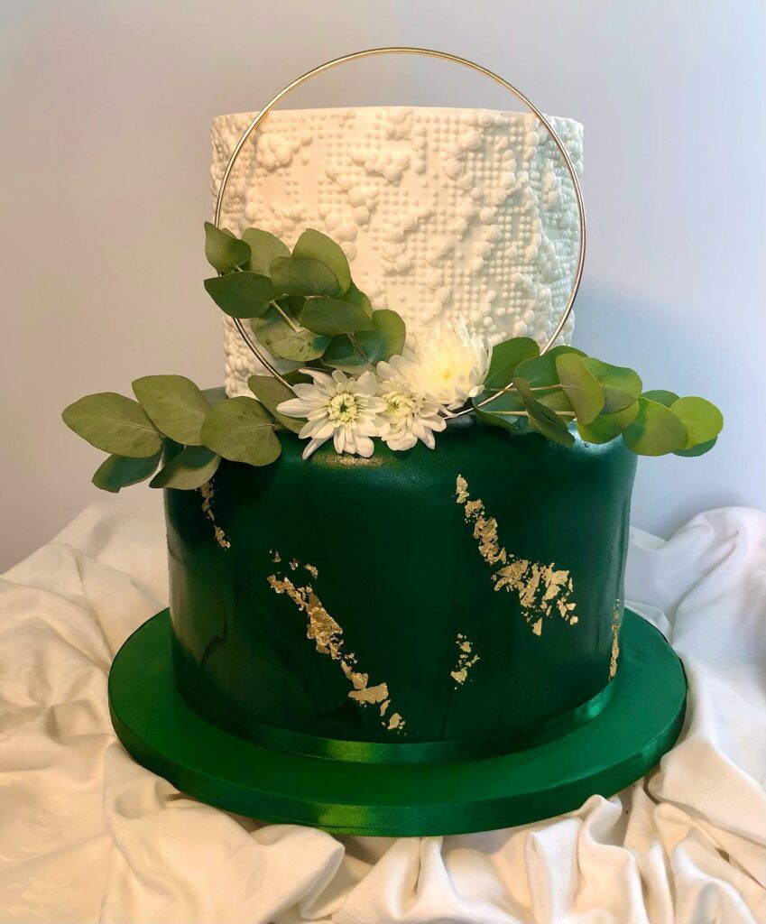white, green and gold vanilla frosting wedding cake