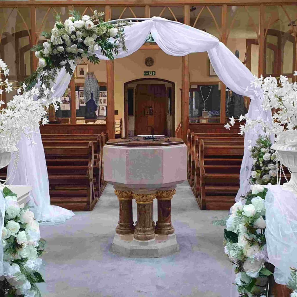 white arch church wedding decor